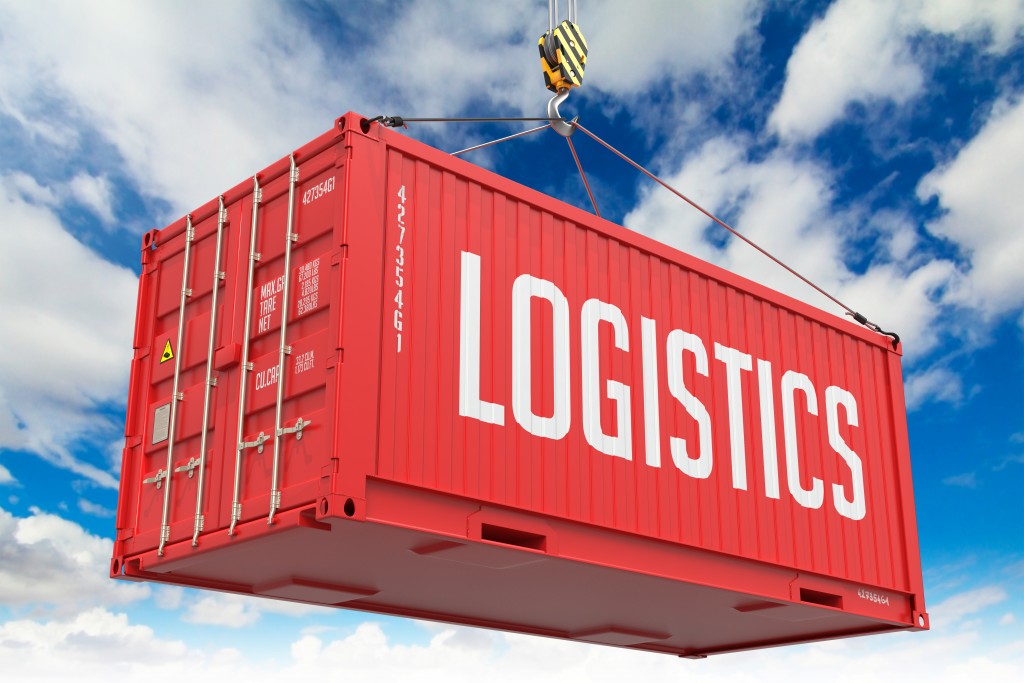 Logistics - Red Hanging Cargo Container on Sky Background.